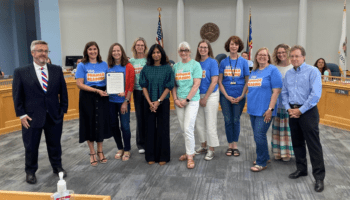 Library staff accept proclamation from the mayor at city council meeting.
